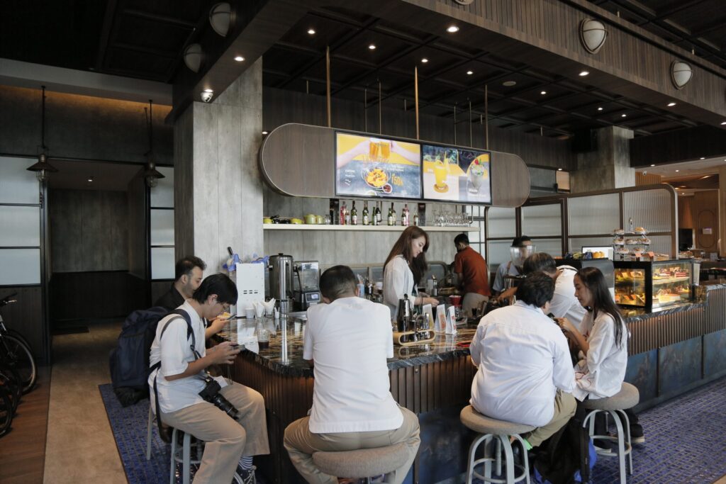 Tempat Nongkrong Seru a group of people sitting at a bar