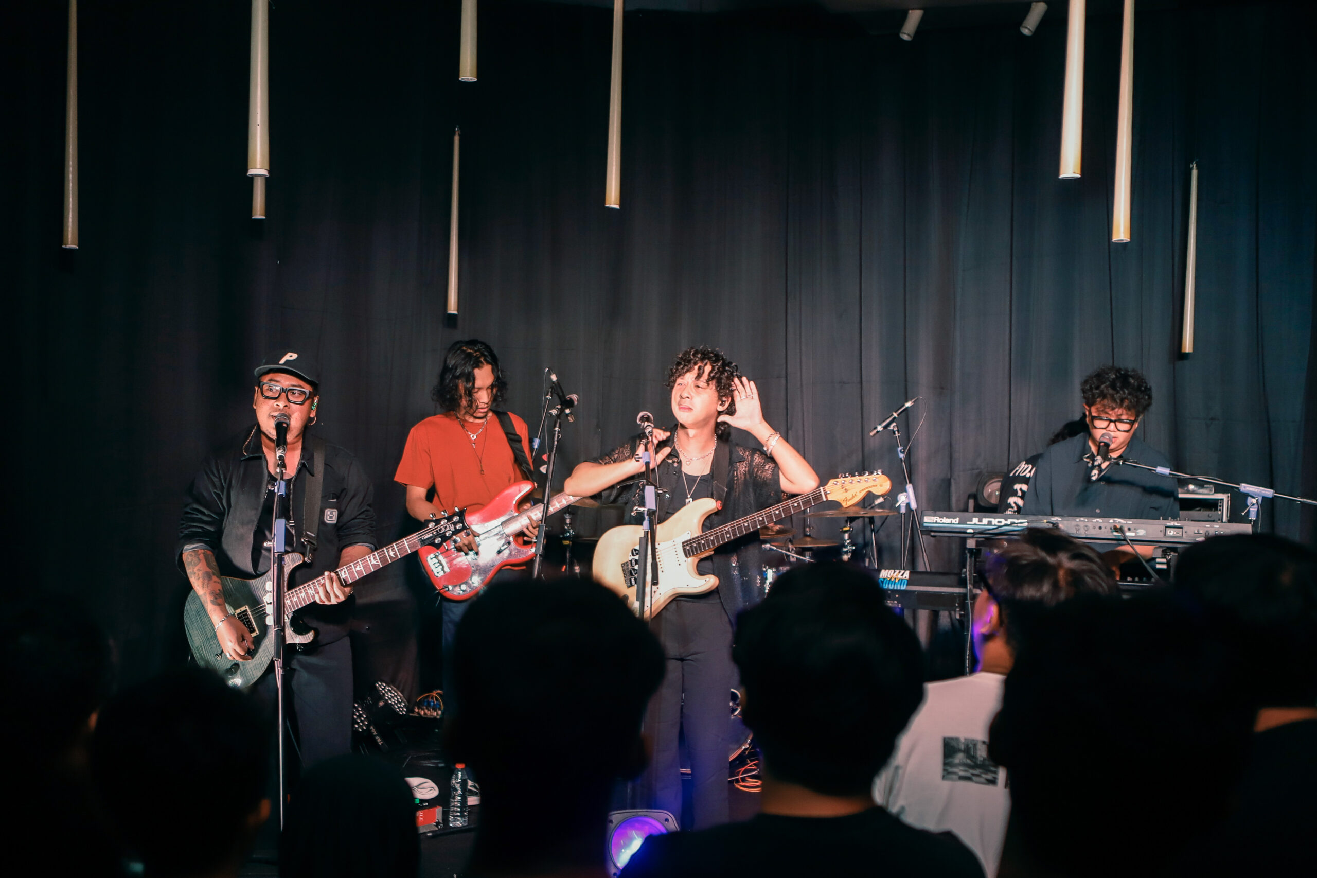 a group of people playing instruments on a stage intimate gigs